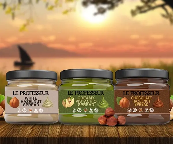 Le Professeur hazelnut and pistachio spreads displayed against a scenic sunset lake backdrop.